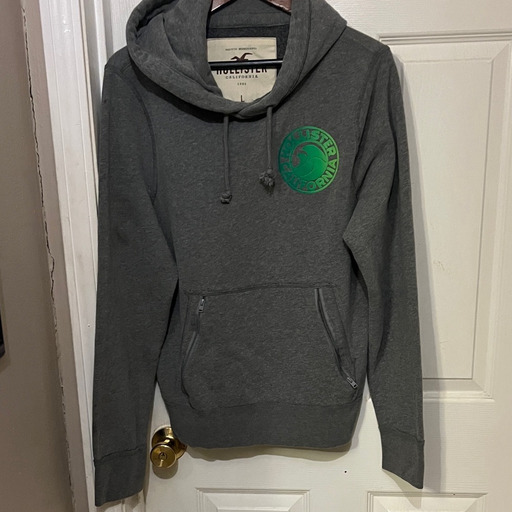 Vintage Hollister Men's Dark Gray Hoodie with Green Emblem very good condition